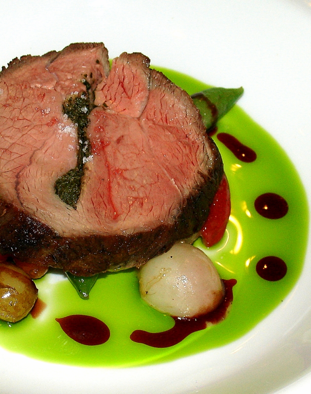 Agneau roti, legumes d'ete Anchoide and parsley stuffed leg of lamb on summer vegetables